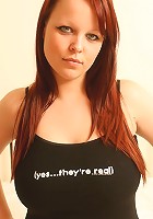 Redheaded busty teen shows off her landing strip