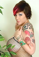 Busty tattooed whore strips out of her fishnet dress and stockings