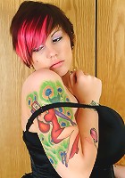 Slutty alt girl poses in her tight black skirt and corset showing off her huge tits