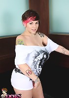 Dors Feline strips out of her dress in the club and plays with her tits and pussy