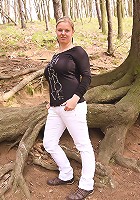 Sima strips to show off her melons and curvy body in a forest