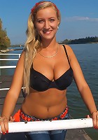 Sweet awesome blondie with big natural mammaries strips at the beach