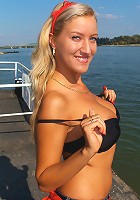 Sweet awesome blondie with big natural mammaries strips at the beach