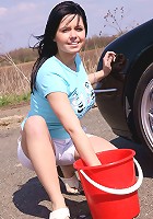 Busty teen washes her car and soaps up her massive tits