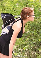 Cute girl with glasses tanning in nature